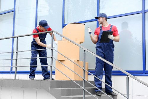 Bulky furniture removal team loading a wardrobe for disposal