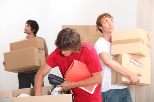 Packed boxes and furniture ready for collection by local movers