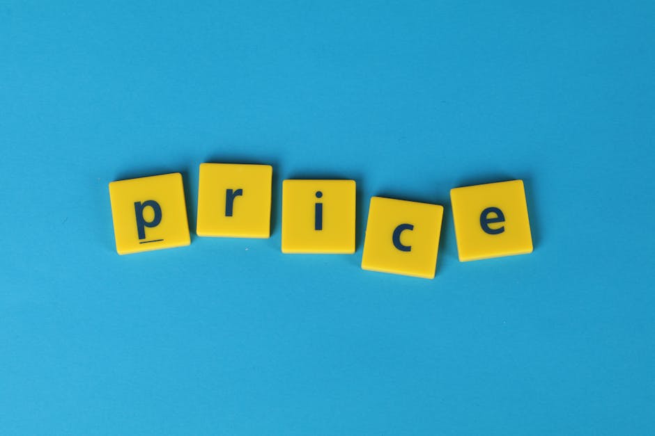 The image features the word 'price' spelled out with five yellow plastic letter tiles, each displaying a black lowercase letter, arranged in a slightly curved line on a bright blue background. The til